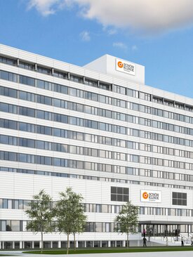 Klinikgebäude der Schön Klinik Düsseldorf mit Zugang, großen Fenstern, breiter Eingangstreppe und Kliniklogo