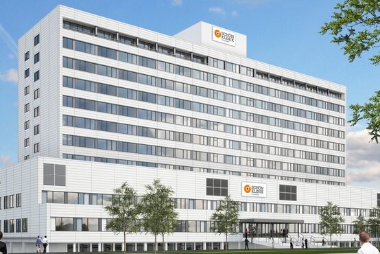 Modernes Klinikgebäude der Schön Klinik Düsseldorf mit heller Fassade, großem Logo, Eingang und Grünflächen