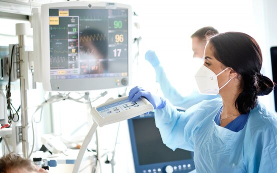 Pflegekraft bedient Überwachungsmonitor auf neurologischer Intensivstation im Krankenhaus